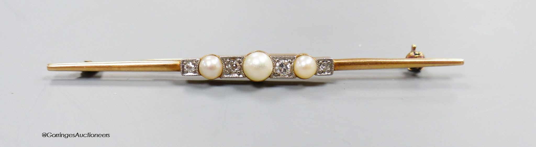 A stylish 14k gold diamond and pearl bar brooch, gross 4.5g, 7cm.